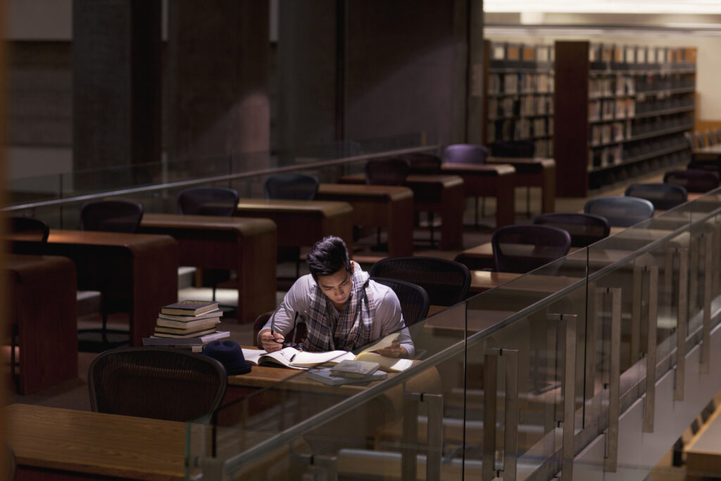 Student studying in dark library