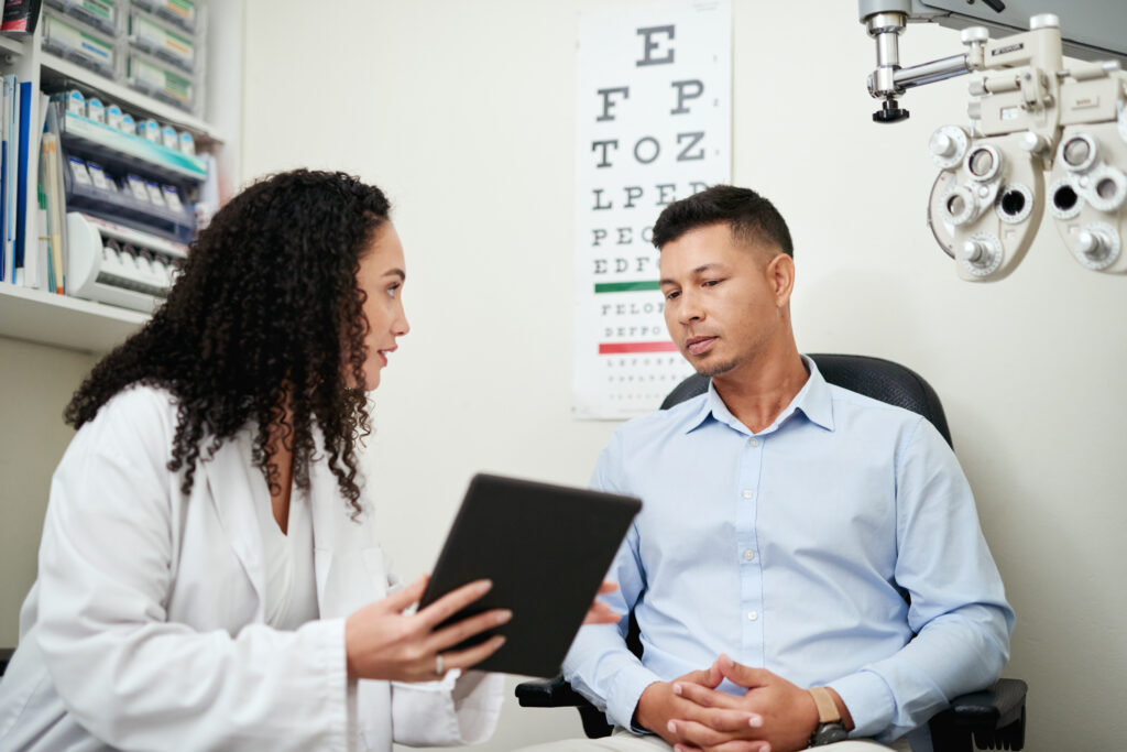 Doctor meeting with patient in front of eye chart