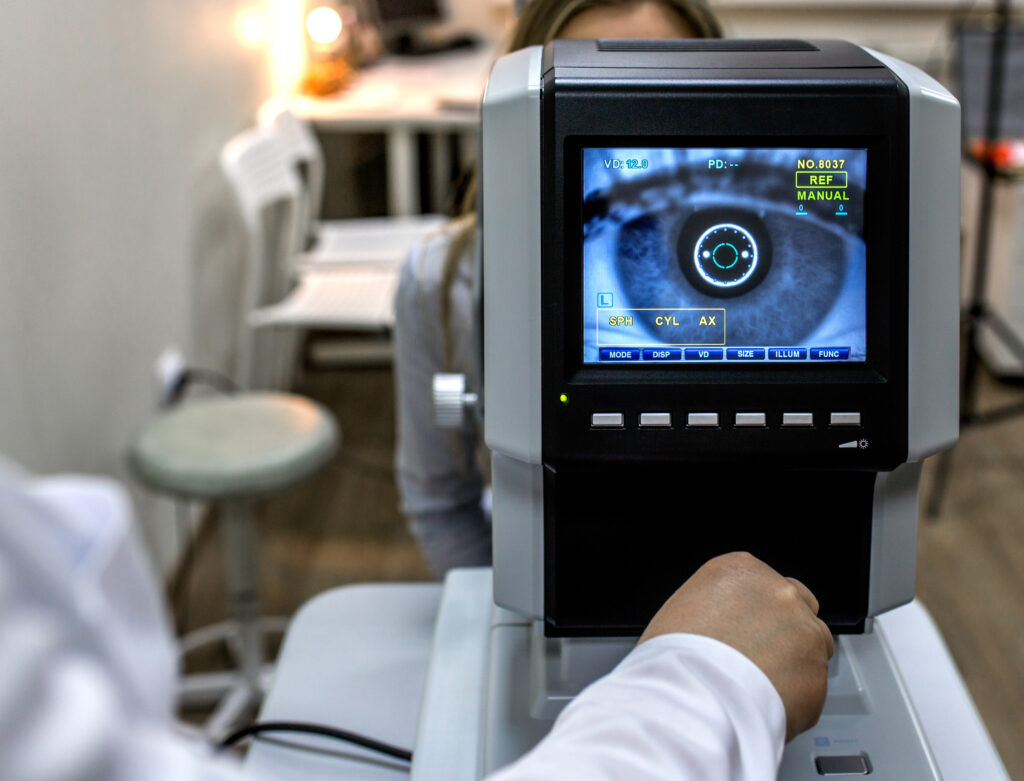 optometrist examining female patient in clinic